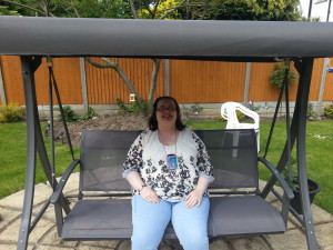 Lynsey on the swing enjoying the spacious garden and wonderful weather.